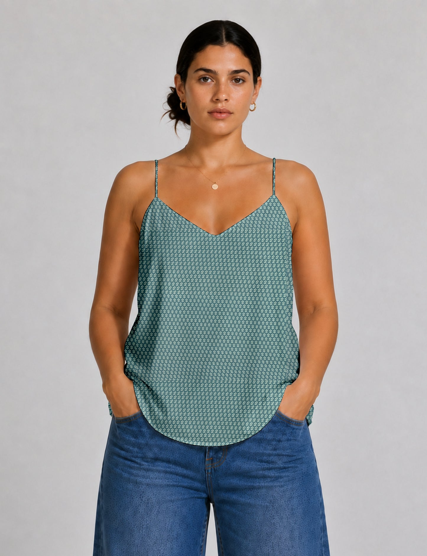 Women's sleeveless slip top with a relaxed straight fit, soft V-neckline, deep V-back, and delicate spaghetti straps.