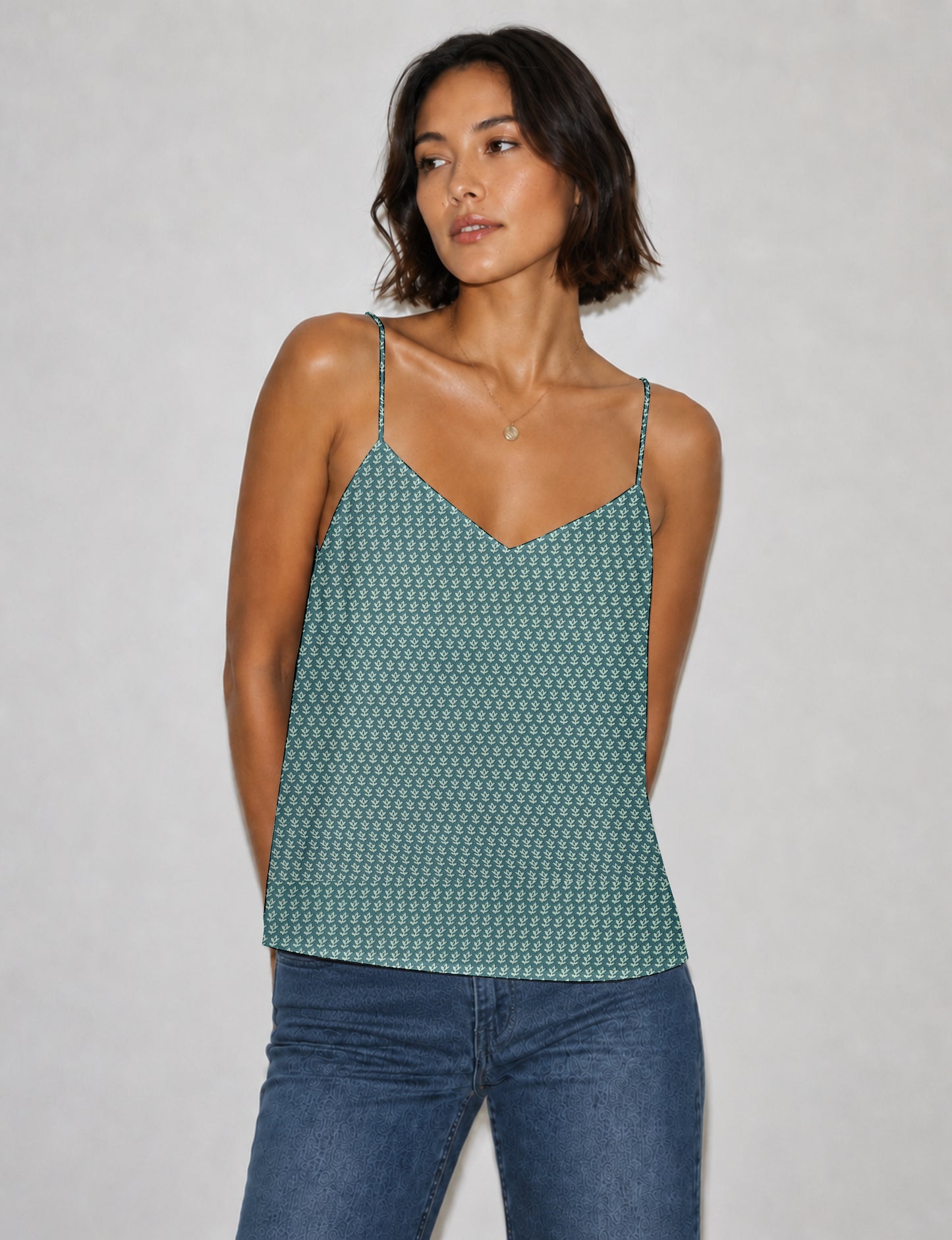 Women's sleeveless slip top with a relaxed straight fit, soft V-neckline, deep V-back, and delicate spaghetti straps.