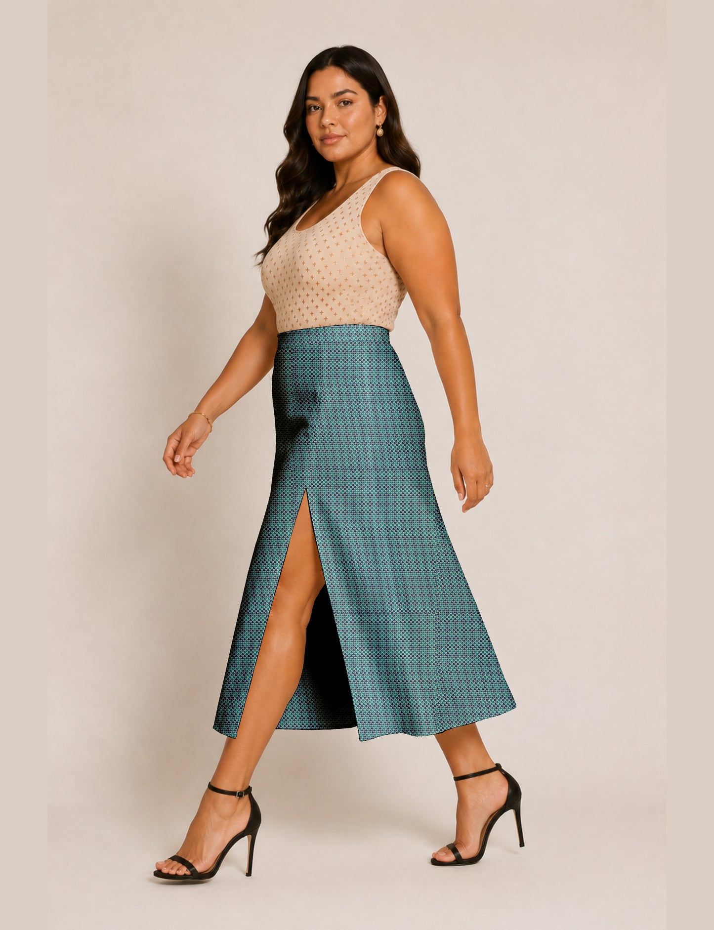 Woman wearing a yellow and black micro patterned A-line skirt with front slit, paired with beige sleeveless top and black
