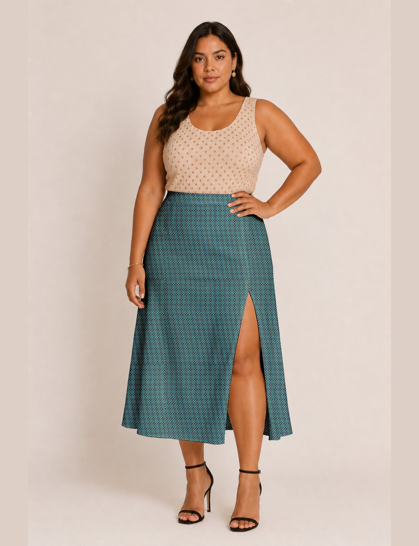 Woman wearing a yellow and black micro patterned A-line skirt with front slit, paired with beige sleeveless top and black