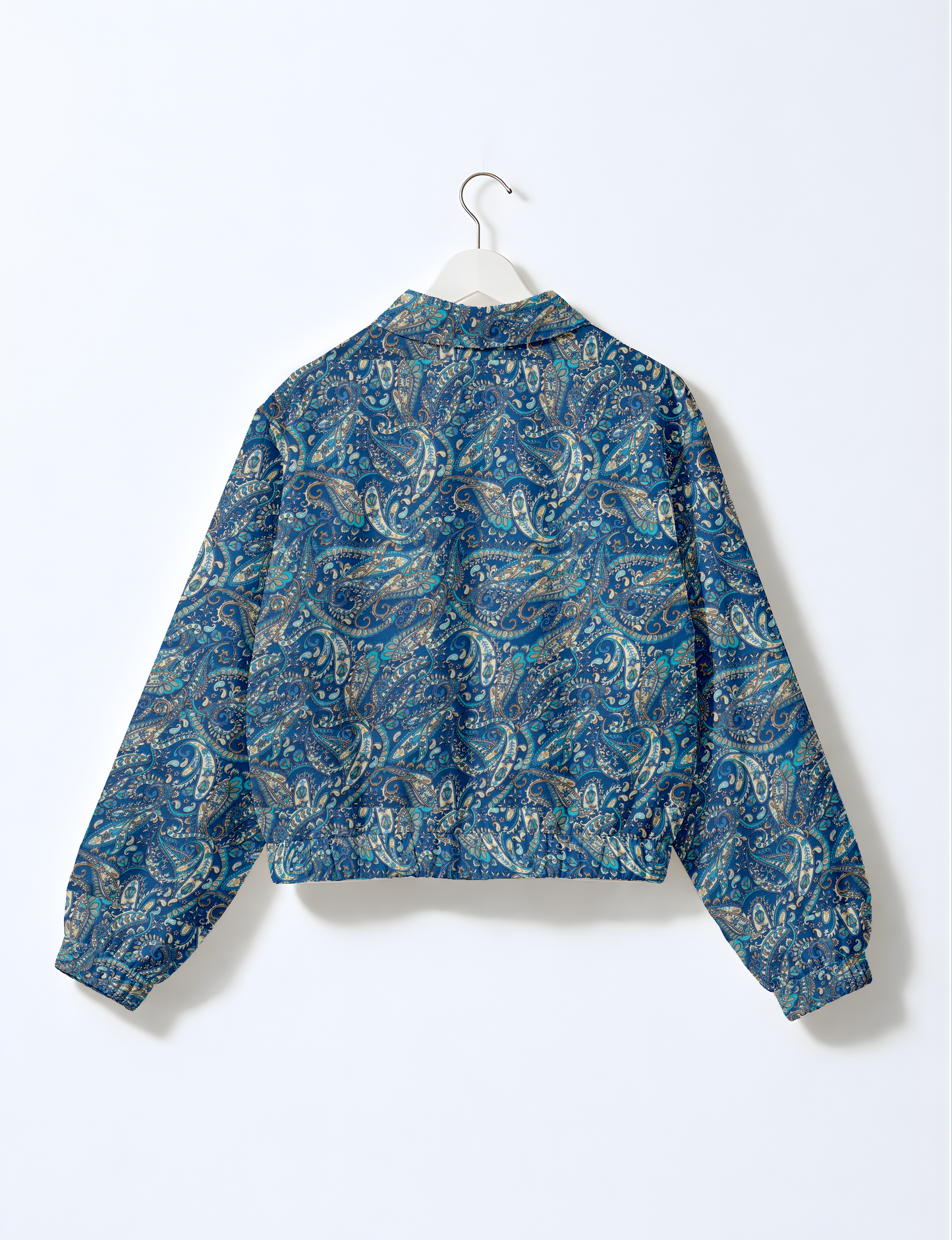 Women's cropped bomber jacket with twin metallic front zippers, welt pockets, elasticated hem and cuffs, and contrast sari print lining.