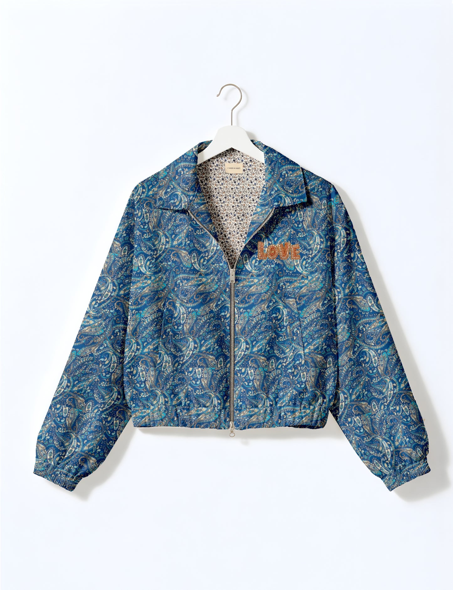 Love Bomber Jacket made from recycled fabric, featuring hand-stitched Aari embroidery. A unique piece of zero-waste clothing, part of the circular fashion movement. Designed with upcycled materials for a stylish yet environmentally friendly clothing choice.