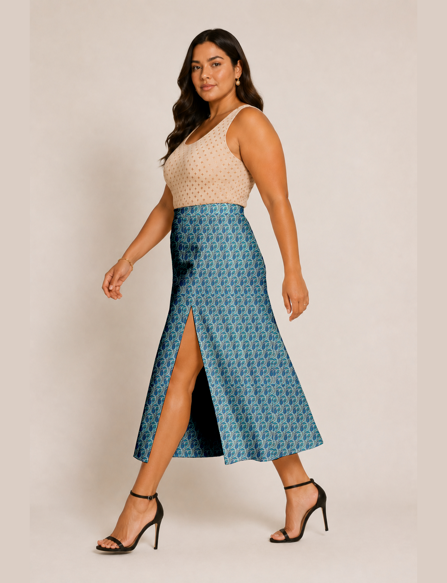 Woman wearing a yellow and black micro patterned A-line skirt with front slit, paired with beige sleeveless top and black