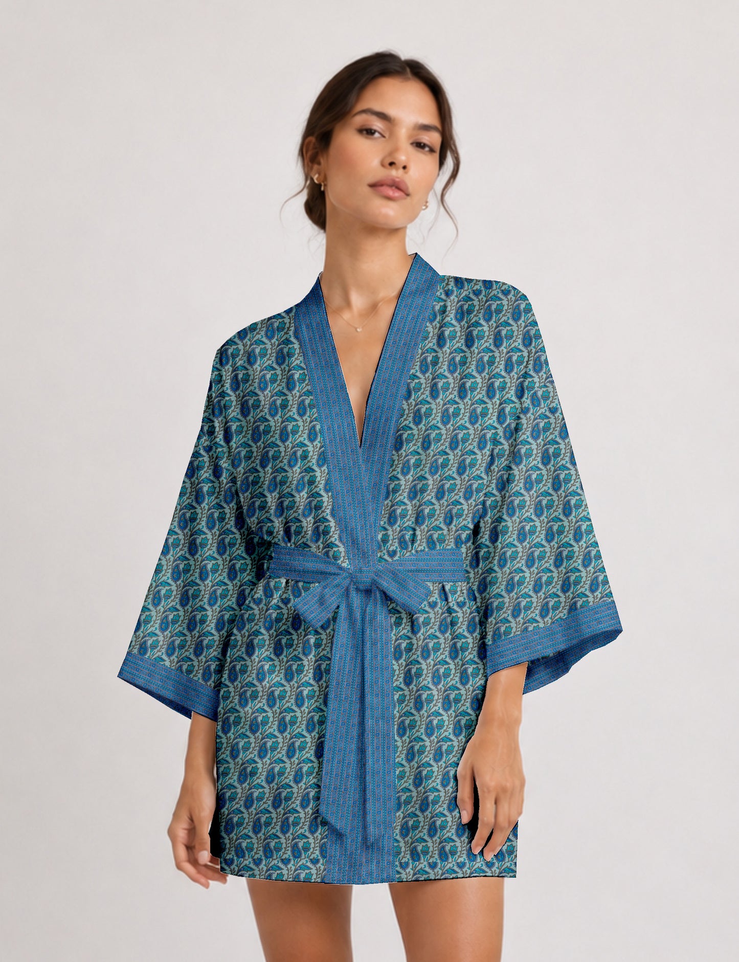 Short kimono robe with wrap front, V-neckline, wide sleeves, waist tie, and concealed skort detail.