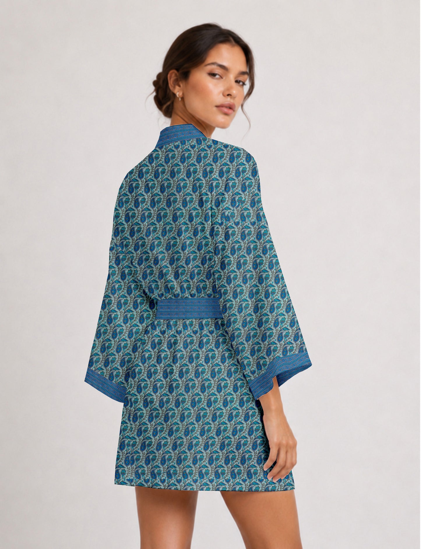 Short kimono robe with wrap front, V-neckline, wide sleeves, waist tie, and concealed skort detail.