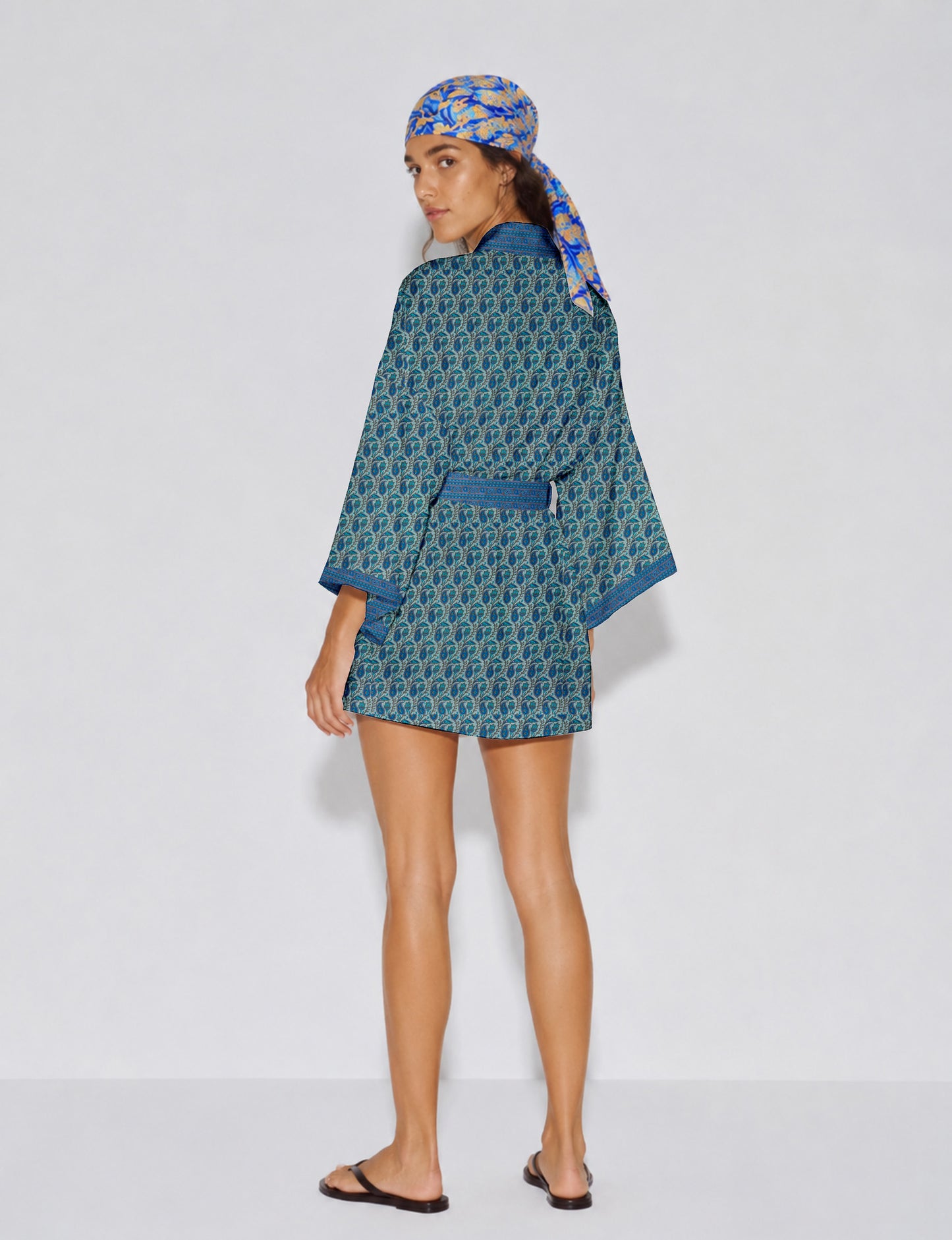 Short kimono robe with wrap front, V-neckline, wide sleeves, waist tie, and concealed skort detail.