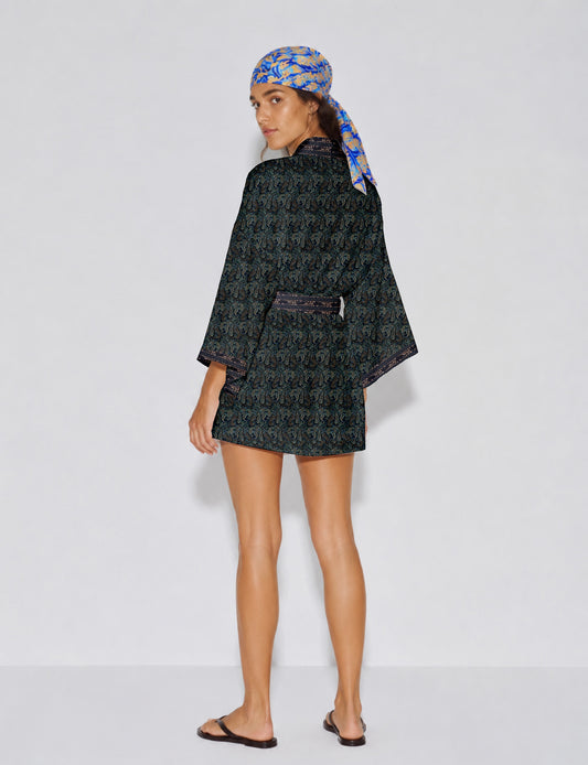Short kimono robe with wrap front, V-neckline, wide sleeves, waist tie, and concealed skort detail.
