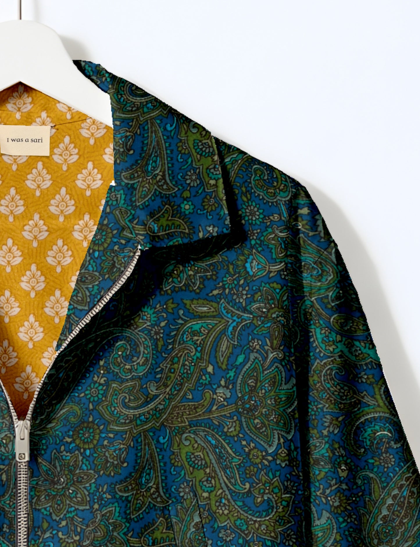 Upcycled Bomber Jacket made from recycled sari materials, featuring a cute cropped shape, elasticated hem and cuffs, and contrast sari print lining. Sustainable apparel promoting eco-friendly fashion and ethical clothing.