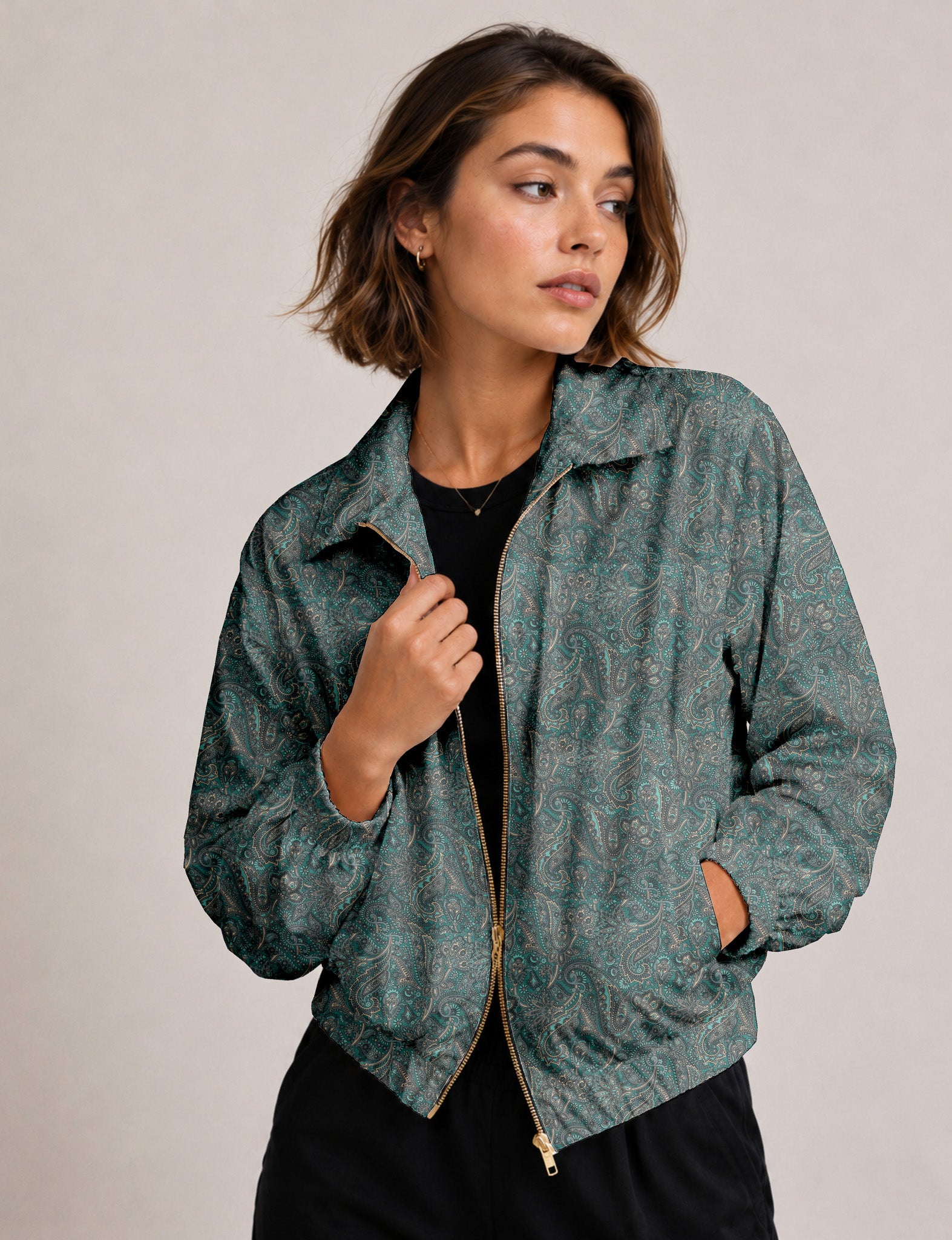 Woman wearing a yellow floral bomber jacket with front zipper, elastic cuffs, and side pockets, shown from front view