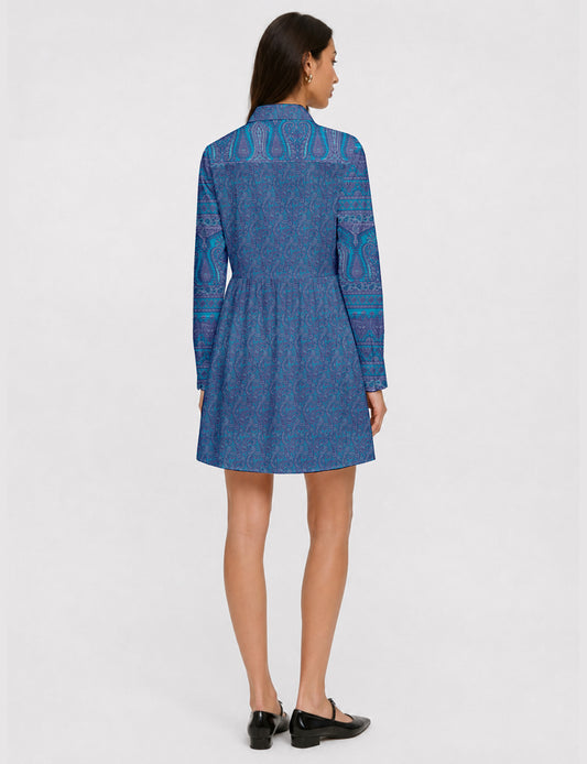 Short shirt dress with a relaxed A-line silhouette, point collar, partial button placket, gathered waist, side pockets, and full-length cuffed sleeves.