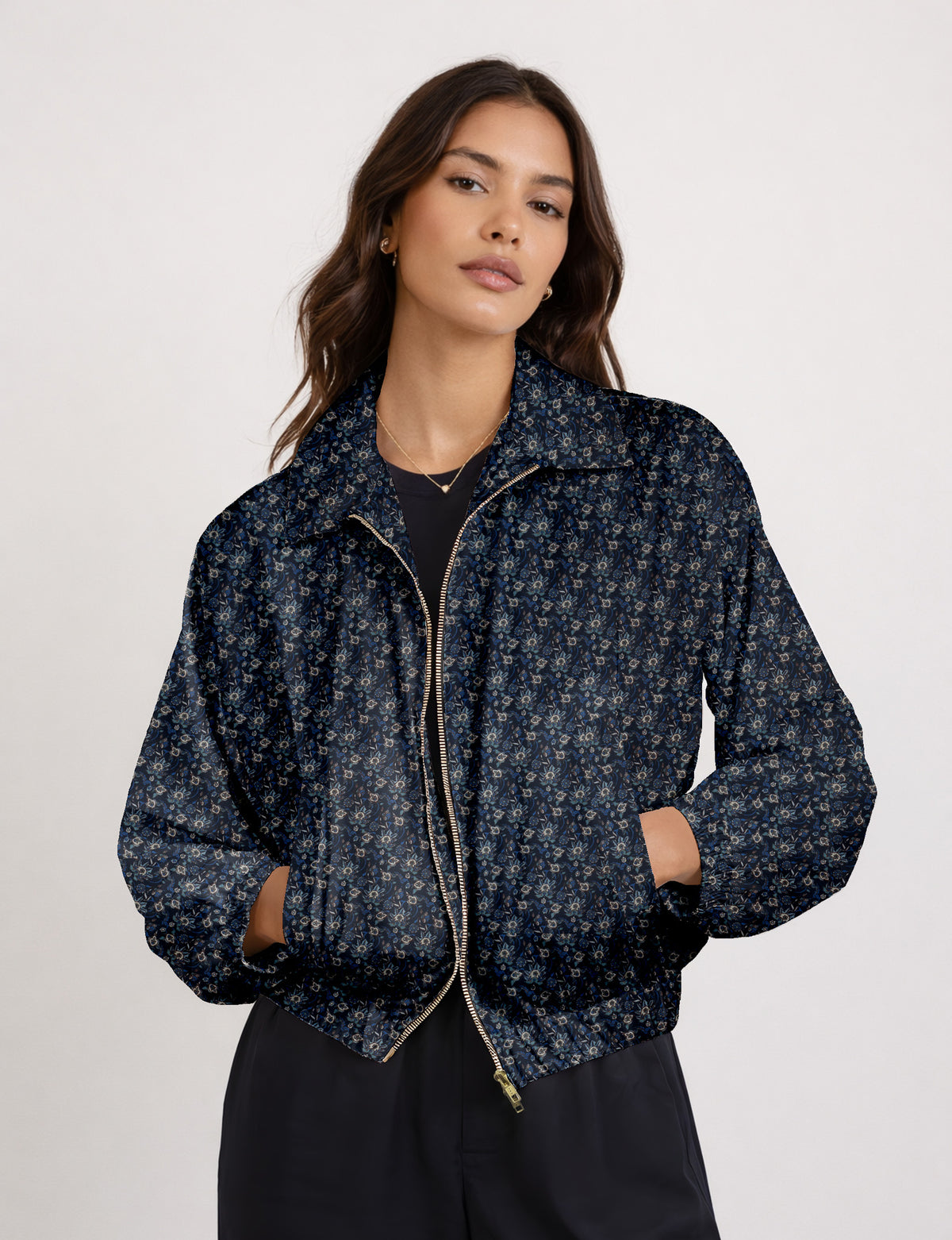 Woman wearing a yellow floral bomber jacket with front zipper, elastic cuffs, and side pockets, shown from front view