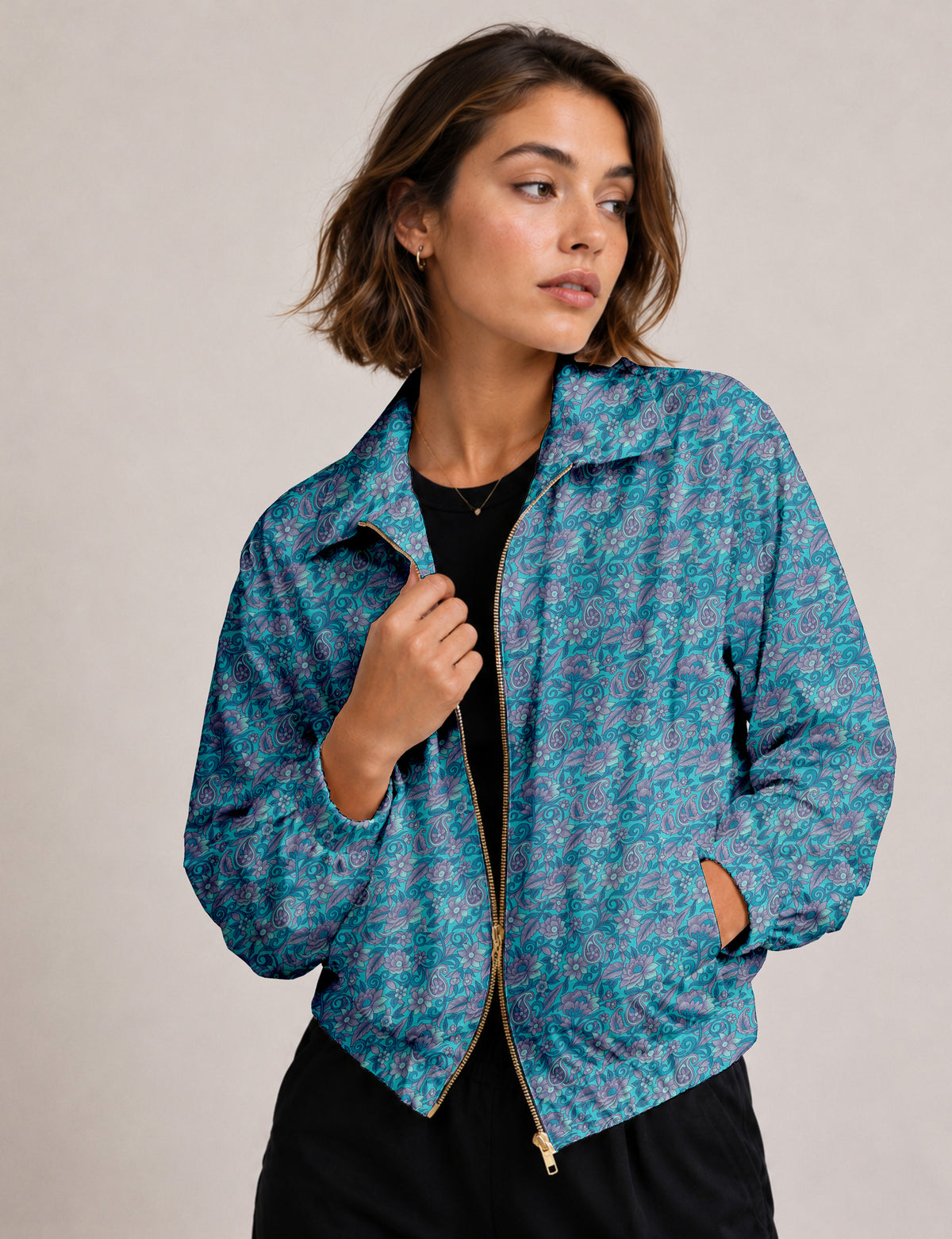Brown floral bomber jacket with front zipper, elastic cuffs and hem, hanging on white hanger, red floral inner lining visible