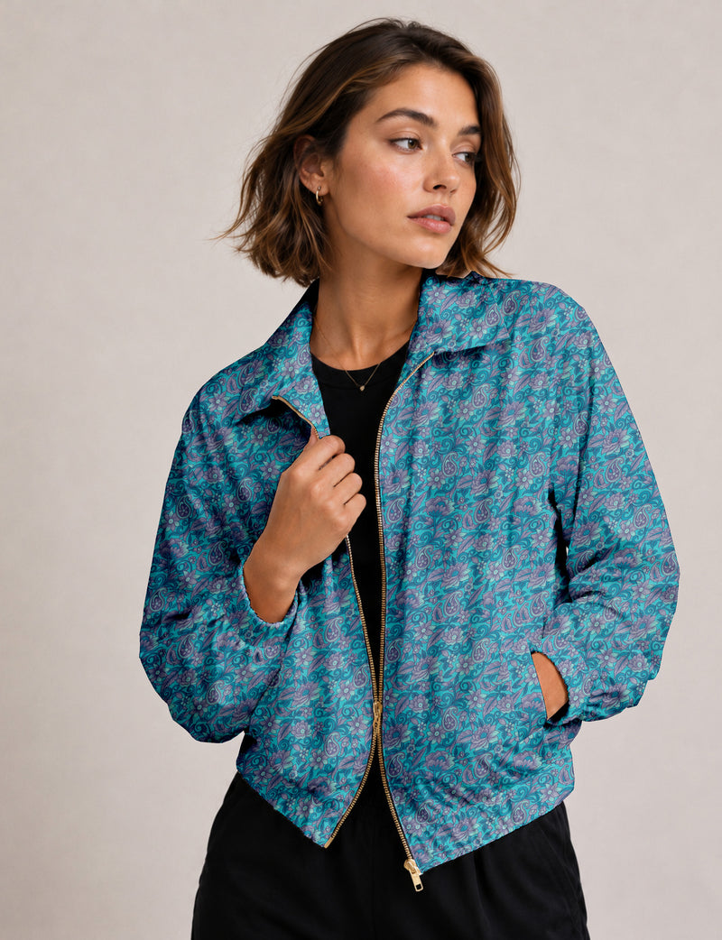Brown floral bomber jacket with front zipper, elastic cuffs and hem, hanging on white hanger, red floral inner lining visible