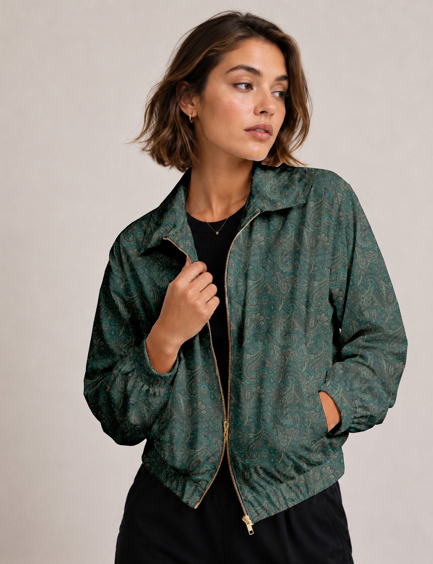 Brown floral bomber jacket with front zipper, elastic cuffs and hem, hanging on white hanger, red floral inner lining visible