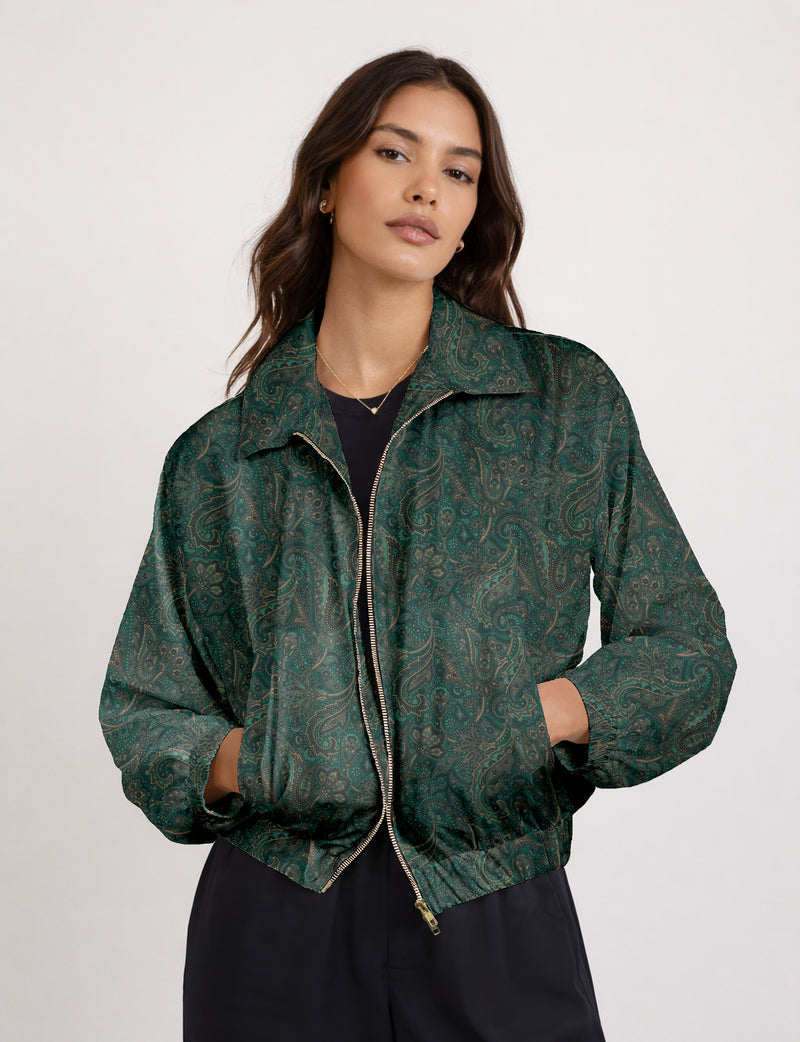 Woman wearing a yellow floral bomber jacket with front zipper, elastic cuffs, and side pockets, shown from front view