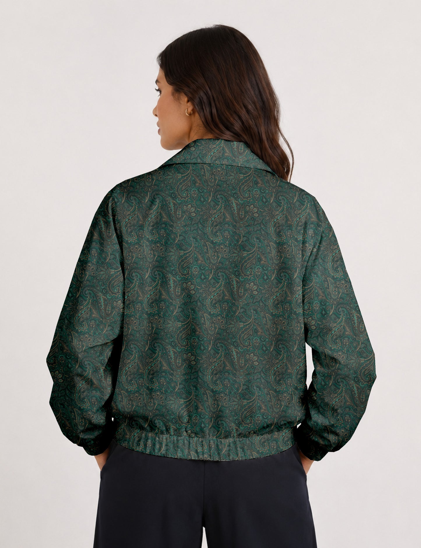 Woman wearing a yellow floral bomber jacket with front zipper, elastic cuffs, and side pockets, shown from front view