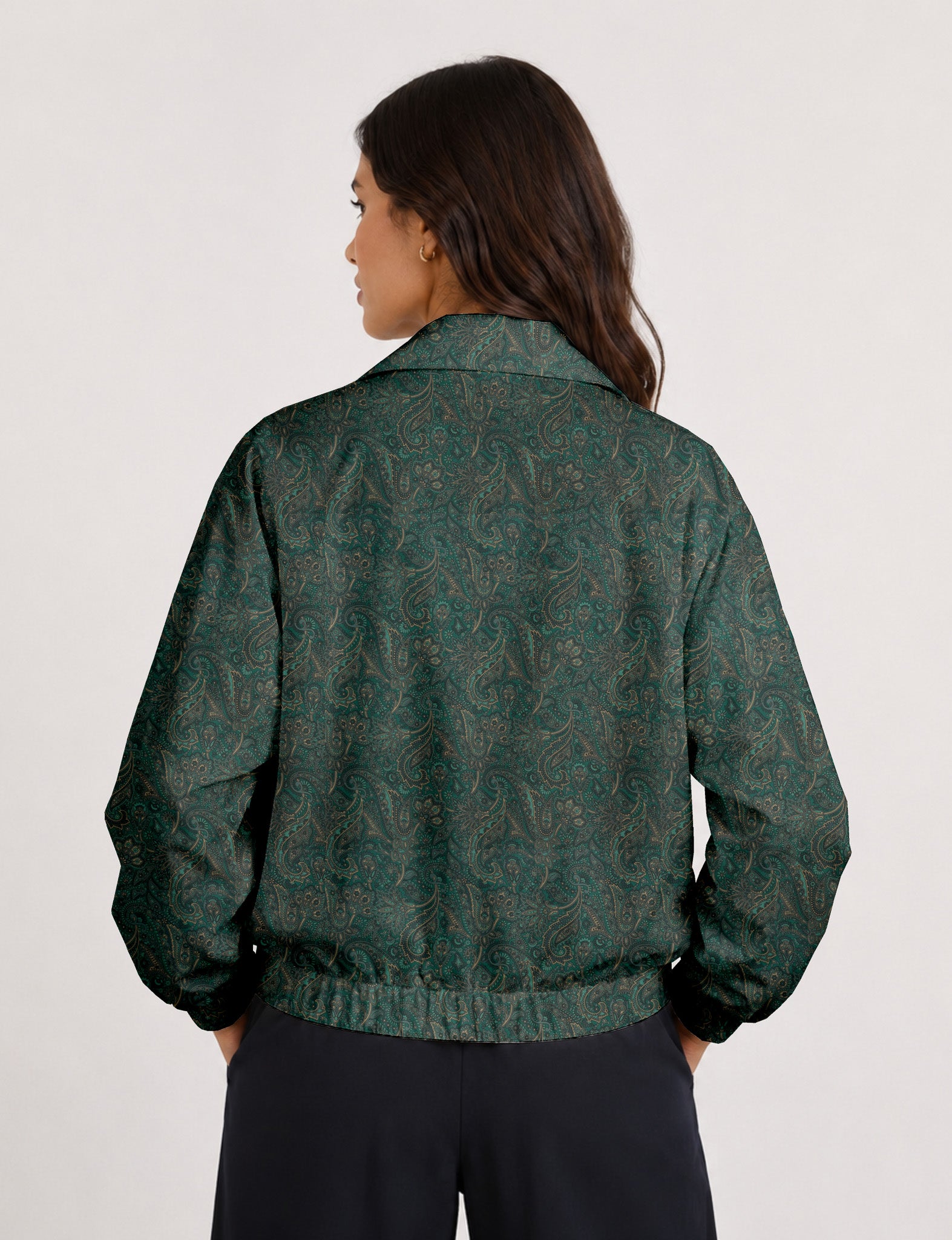 Woman wearing a yellow floral bomber jacket with front zipper, elastic cuffs, and side pockets, shown from front view