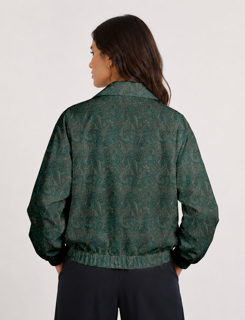 Woman wearing a yellow floral bomber jacket with front zipper, elastic cuffs, and side pockets, shown from front view