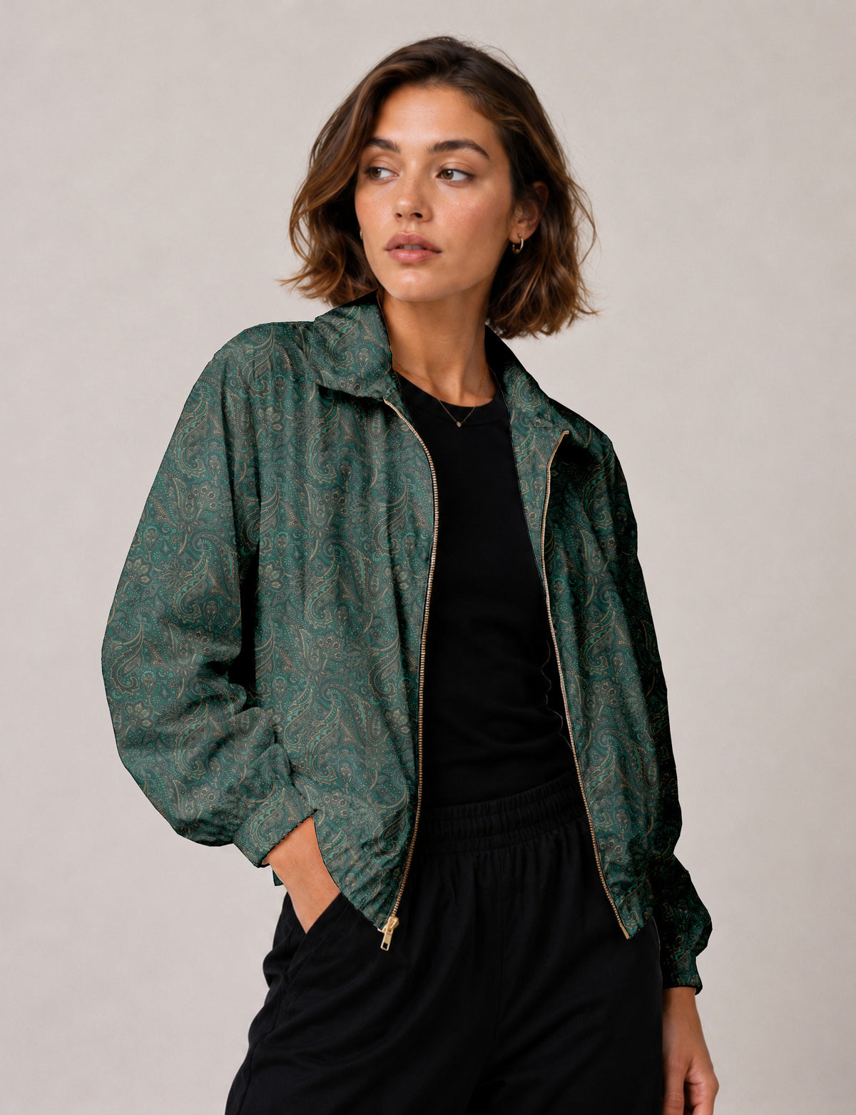 Woman wearing a yellow floral bomber jacket with front zipper, elastic cuffs, and side pockets, shown from front view