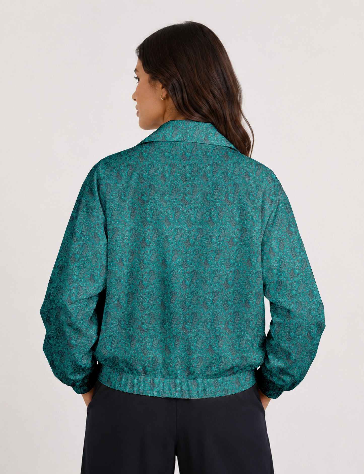 Brown floral bomber jacket with front zipper, elastic cuffs and hem, hanging on white hanger, red floral inner lining visible
