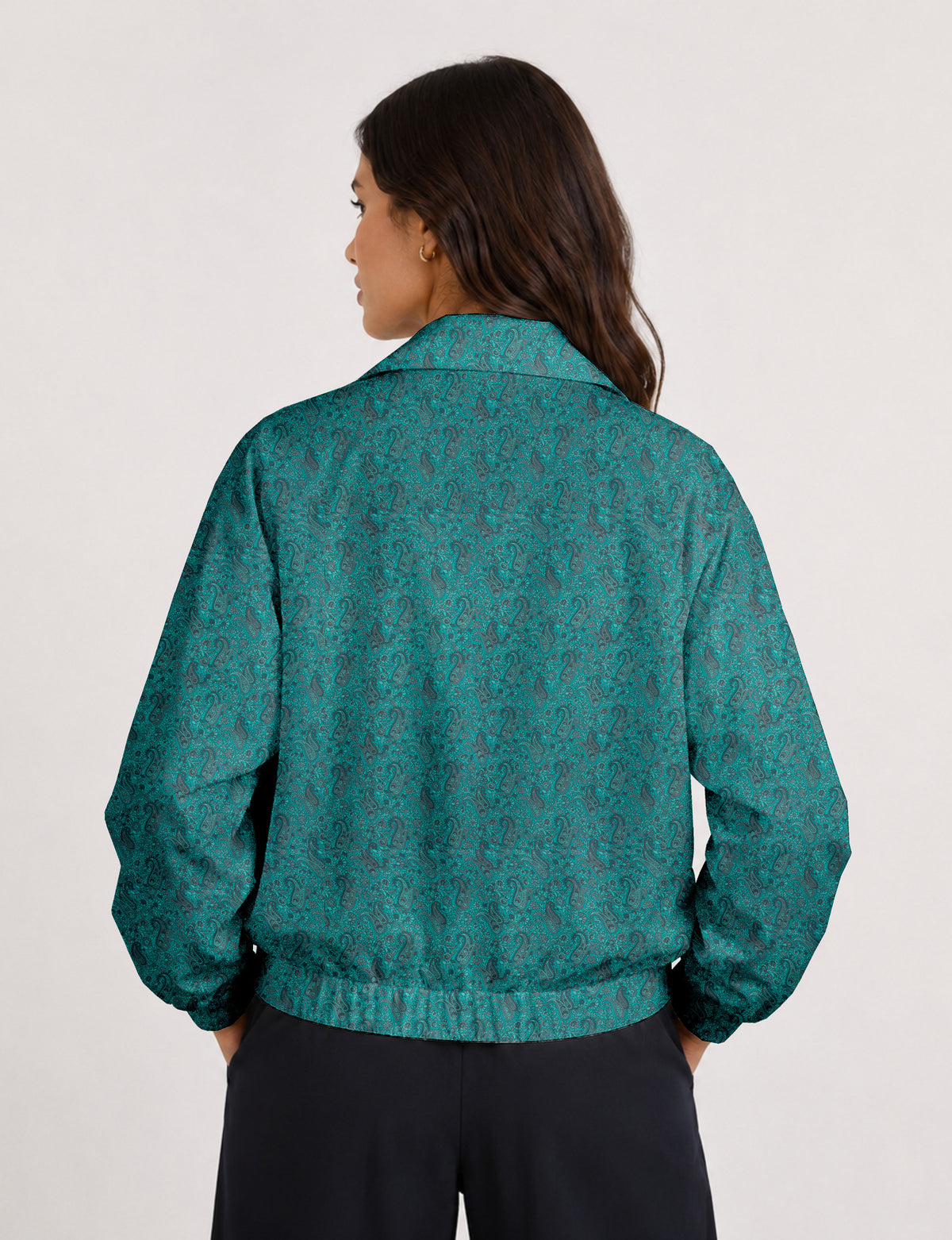 Brown floral bomber jacket with front zipper, elastic cuffs and hem, hanging on white hanger, red floral inner lining visible