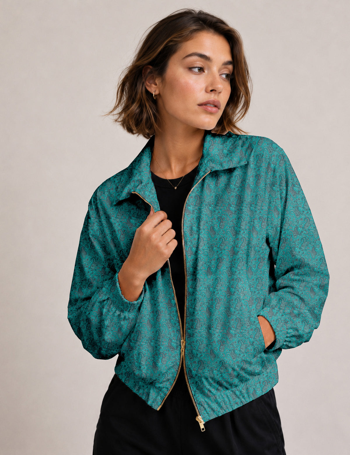 Woman wearing a yellow floral bomber jacket with front zipper, elastic cuffs, and side pockets, shown from front view