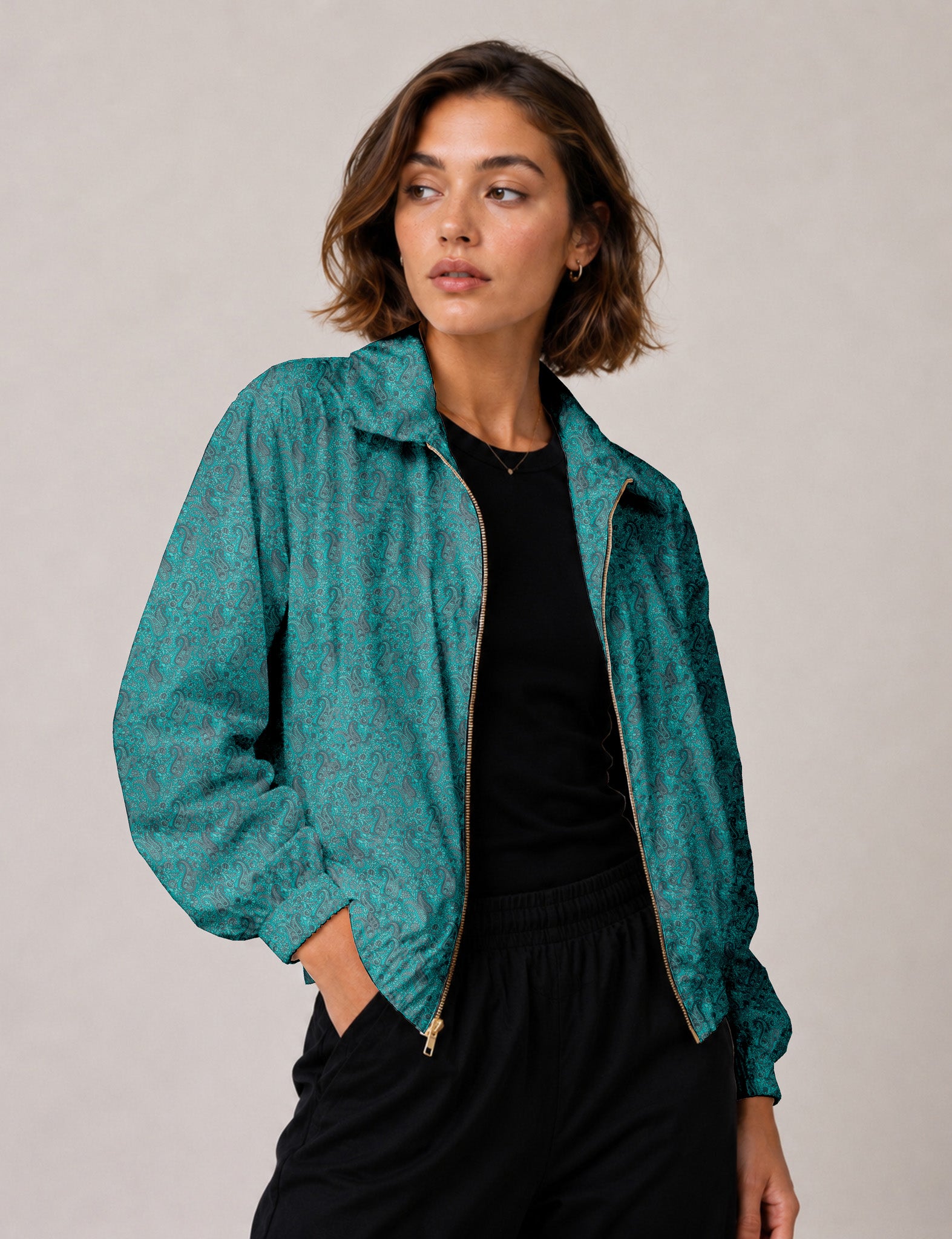 Woman wearing a yellow floral bomber jacket with front zipper, elastic cuffs, and side pockets, shown from front view