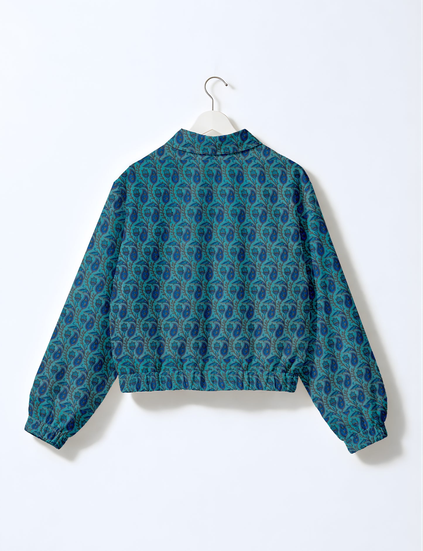 Women's cropped bomber jacket with twin metallic front zippers, welt pockets, elasticated hem and cuffs, and contrast sari print lining.