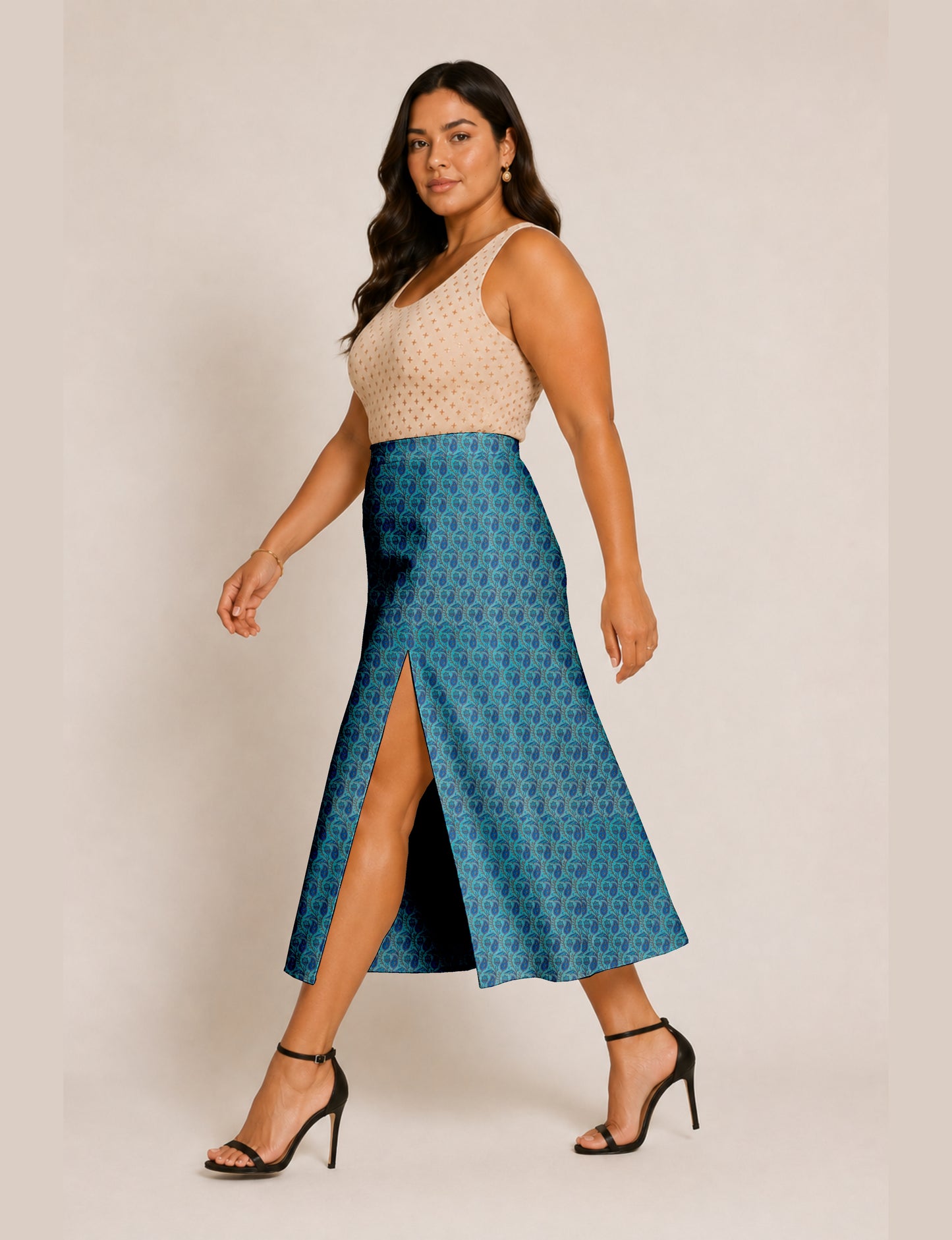 Woman wearing a yellow and black micro patterned A-line skirt with front slit, paired with beige sleeveless top and black
