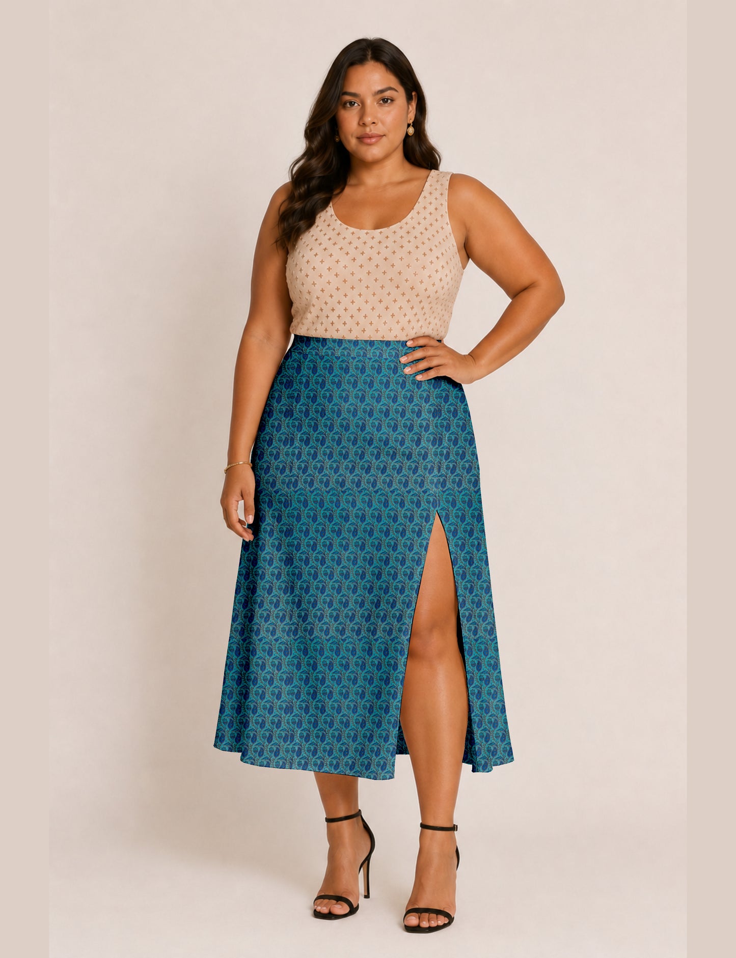 Woman wearing a yellow and black micro patterned A-line skirt with front slit, paired with beige sleeveless top and black