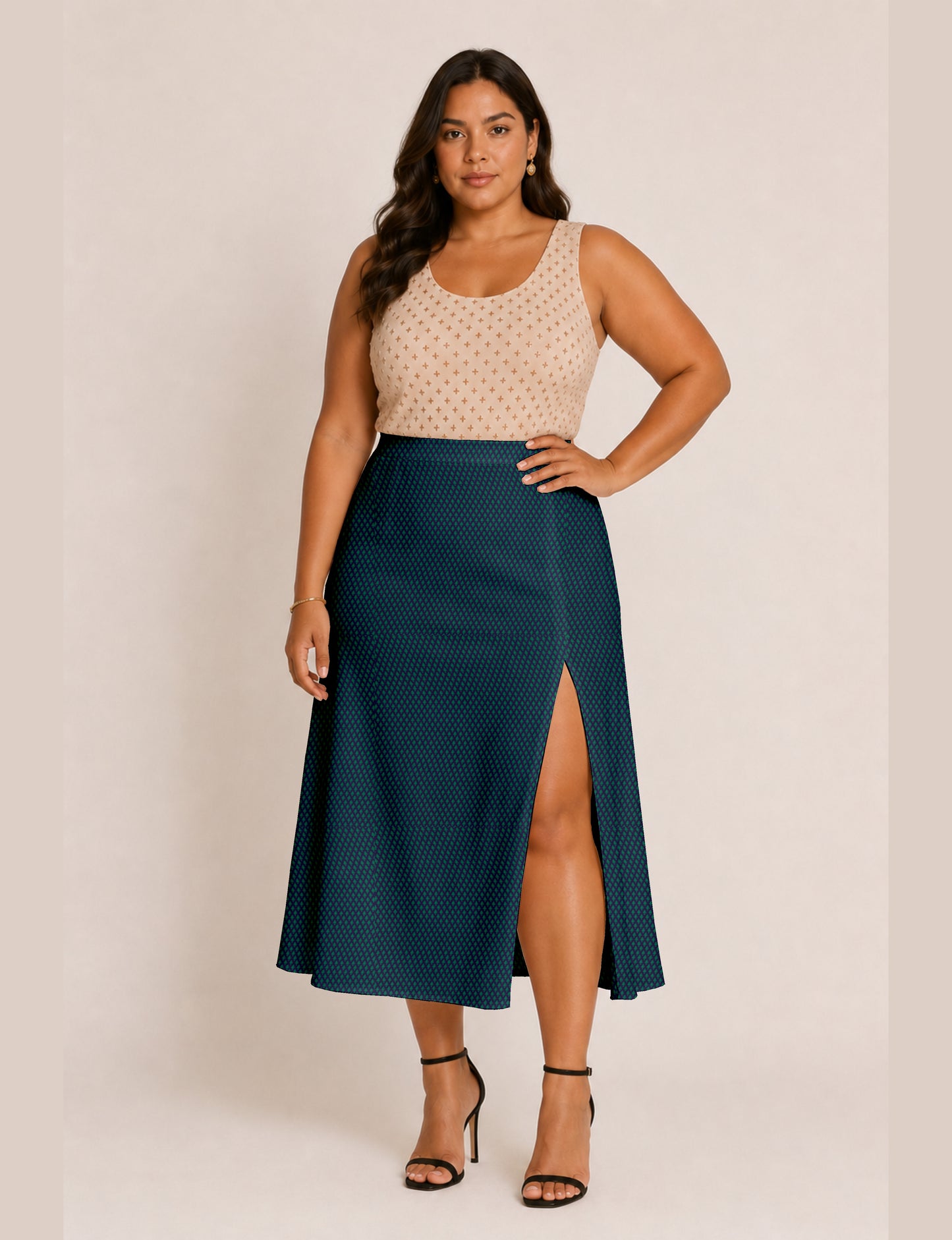 Woman wearing a yellow and black micro patterned A-line skirt with front slit, paired with beige sleeveless top and black