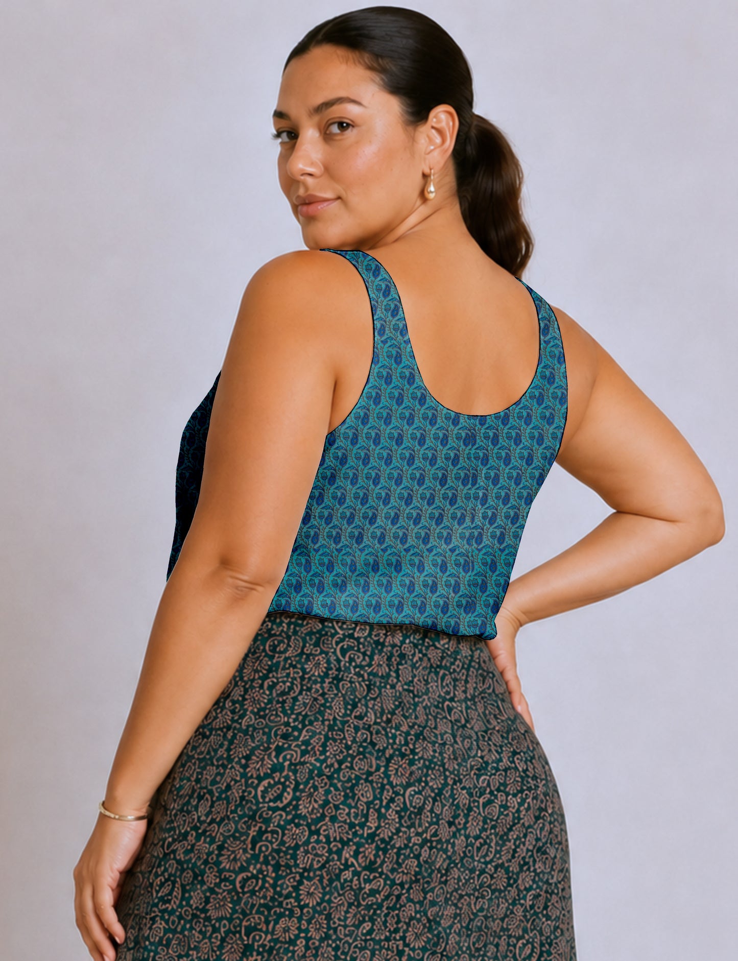Women's sleeveless blouse with a relaxed straight fit, wide scoop neckline, deep scoop back, and hip-length silhouette.