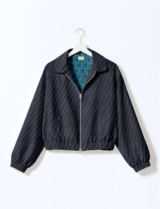 Women's cropped bomber jacket with twin metallic front zippers, welt pockets, elasticated hem and cuffs, and contrast sari print lining.