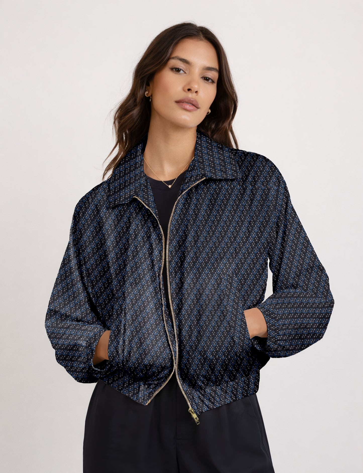 Women's cropped bomber jacket with twin metallic front zippers, welt pockets, elasticated hem and cuffs, and contrast sari print lining.