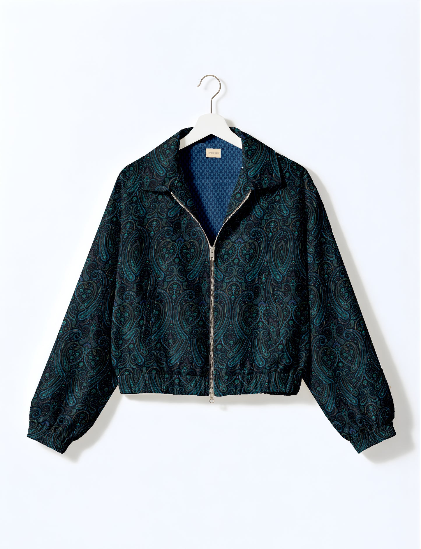 Women's cropped bomber jacket with twin metallic front zippers, welt pockets, elasticated hem and cuffs, and contrast sari print lining.