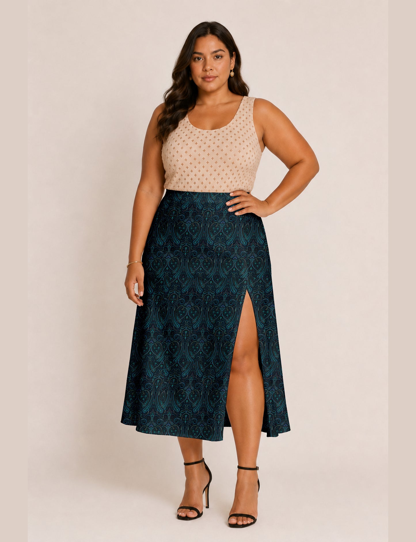 Woman wearing a yellow and black micro patterned A-line skirt with front slit, paired with beige sleeveless top and black