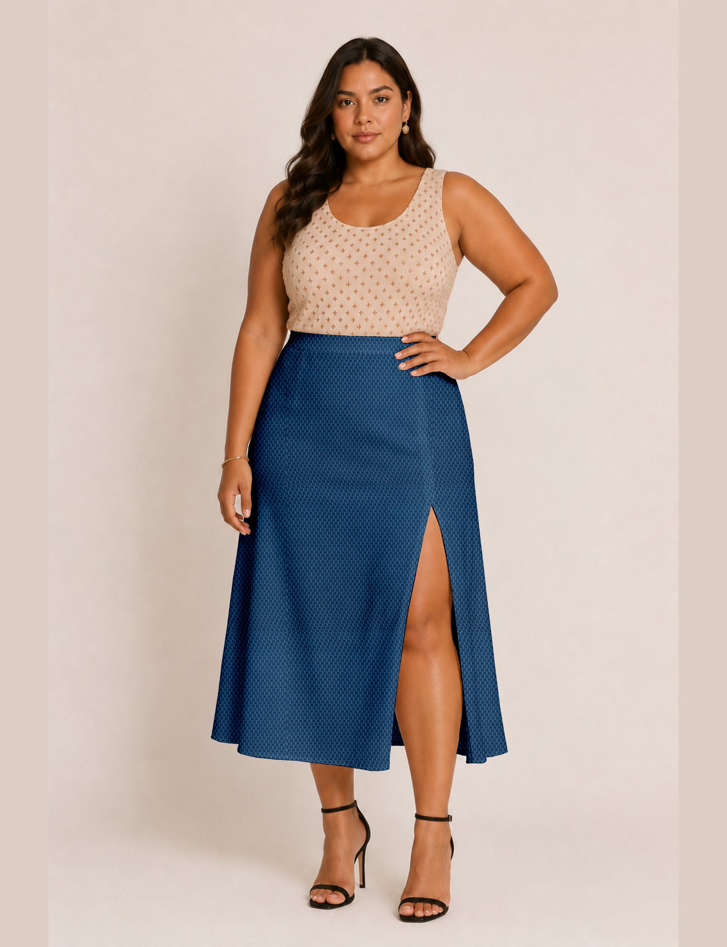 Woman wearing a yellow and black micro patterned A-line skirt with front slit, paired with beige sleeveless top and black