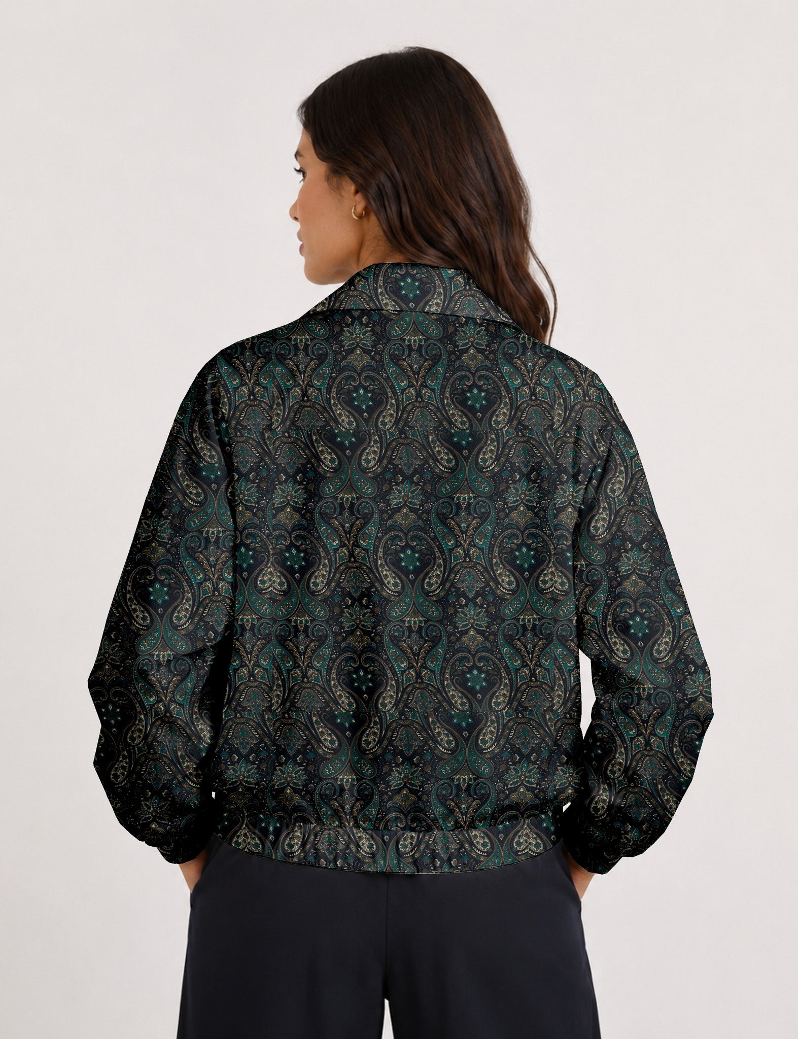 Woman wearing a yellow floral bomber jacket with front zipper, elastic cuffs, and side pockets, shown from front view