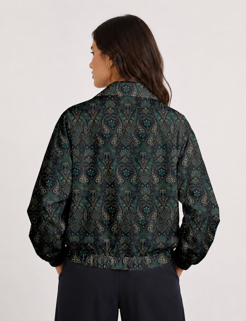 Woman wearing a yellow floral bomber jacket with front zipper, elastic cuffs, and side pockets, shown from front view