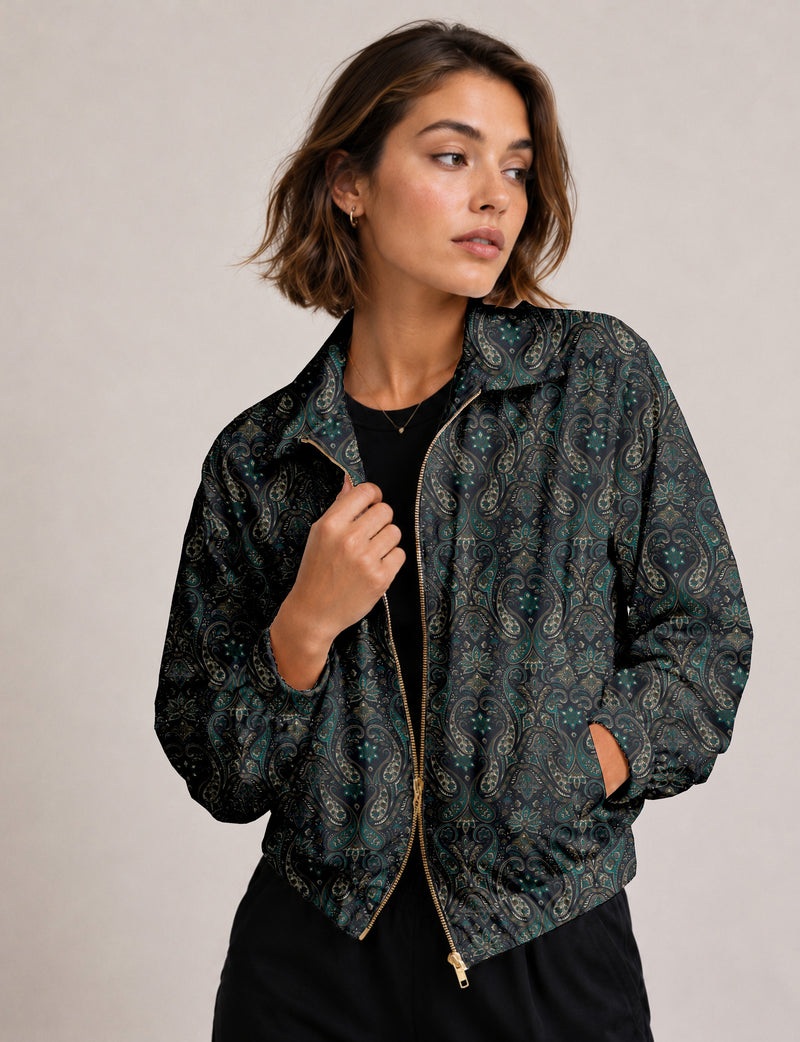 Woman wearing a yellow floral bomber jacket with front zipper, elastic cuffs, and side pockets, shown from front view