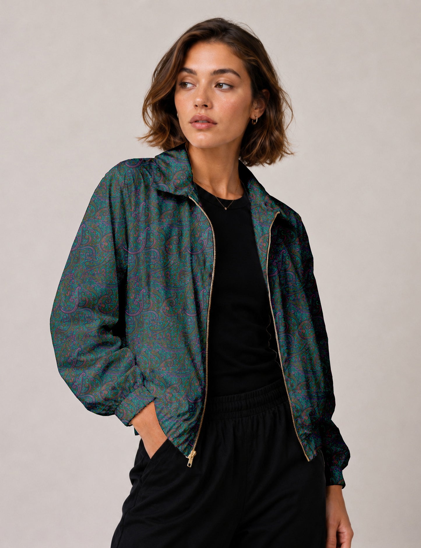 Woman wearing a yellow floral bomber jacket with front zipper, elastic cuffs, and side pockets, shown from front view