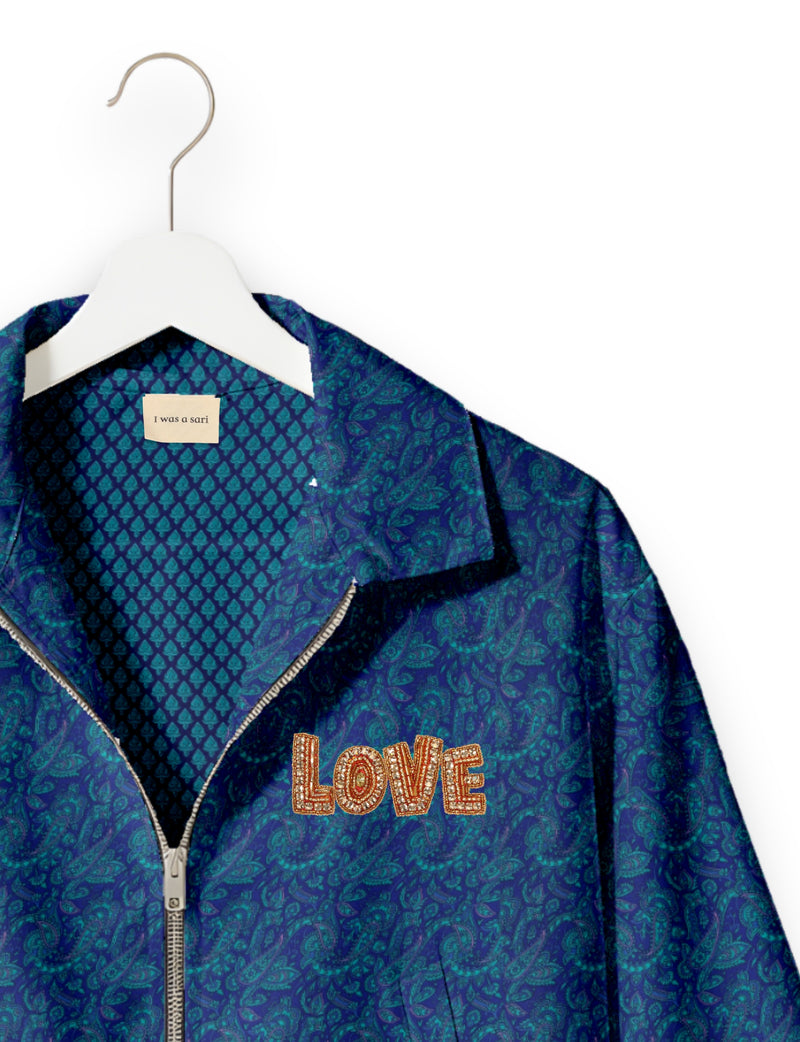 Love Bomber Jacket made from recycled fabric, featuring hand-stitched Aari embroidery. A unique piece of zero-waste clothing, part of the circular fashion movement. Designed with upcycled materials for a stylish yet environmentally friendly clothing choice.
