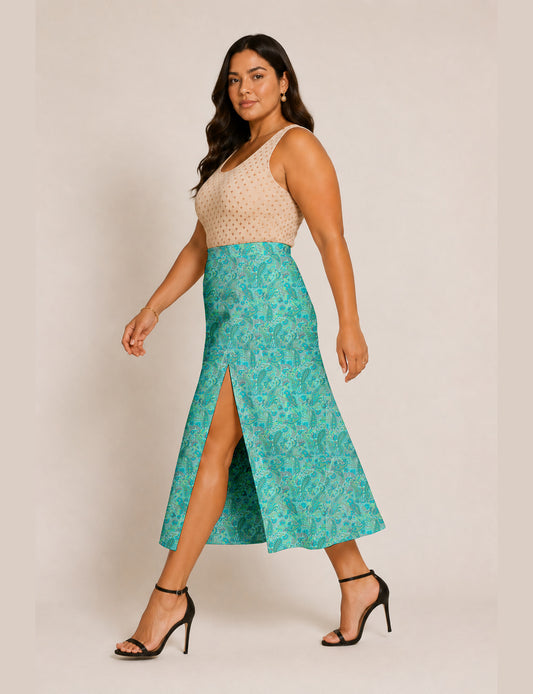 Woman wearing a yellow and black micro patterned A-line skirt with front slit, paired with beige sleeveless top and black