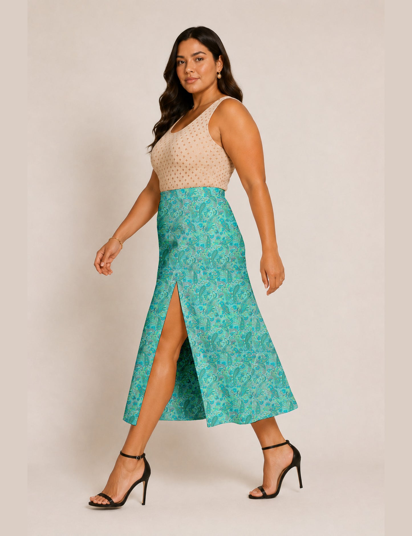 Woman wearing a yellow and black micro patterned A-line skirt with front slit, paired with beige sleeveless top and black