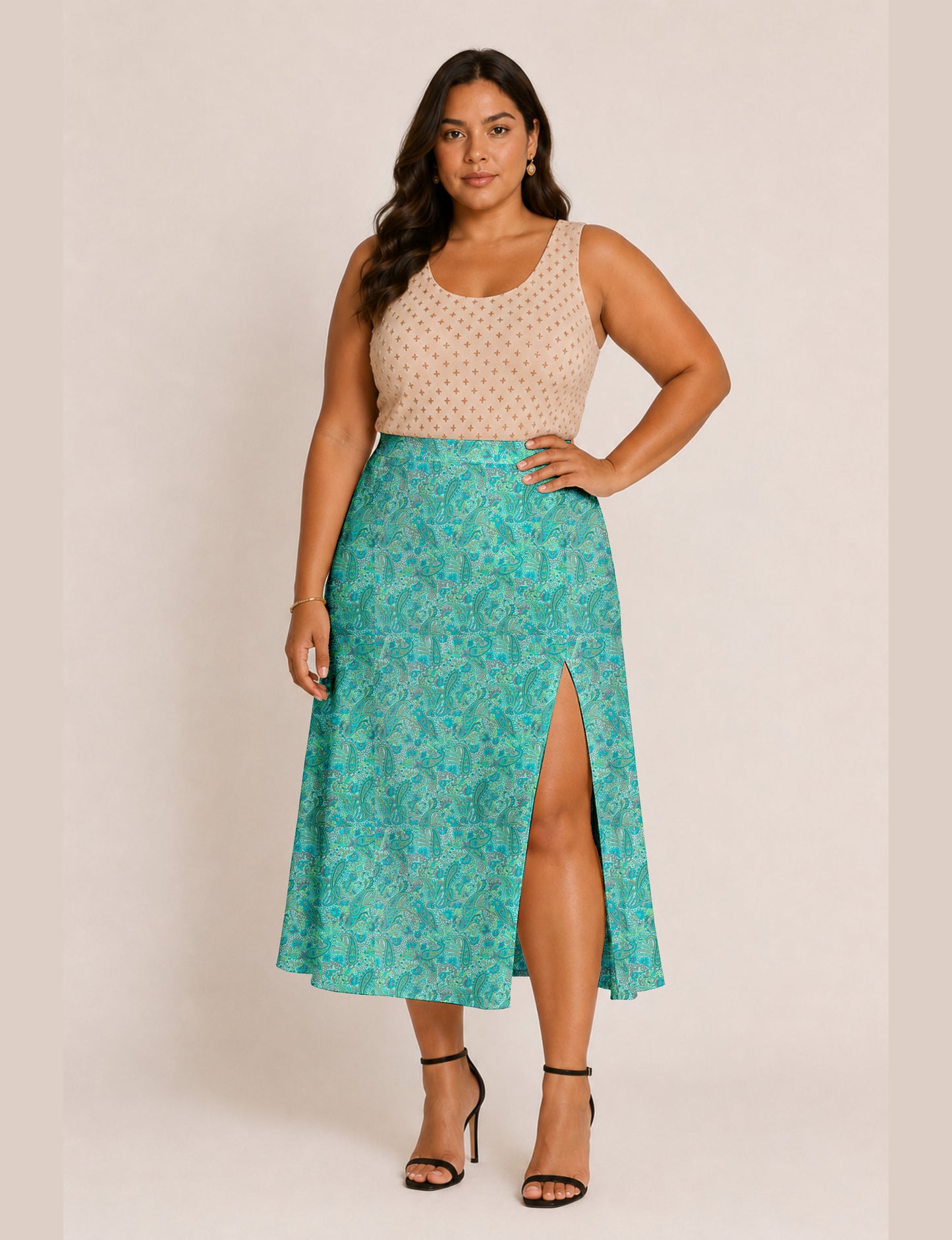 Woman wearing a yellow and black micro patterned A-line skirt with front slit, paired with beige sleeveless top and black