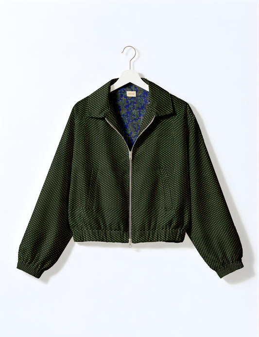 Women's cropped bomber jacket with twin metallic front zippers, welt pockets, elasticated hem and cuffs, and contrast sari print lining.