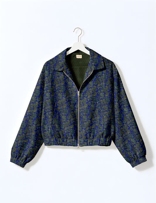 Women's cropped bomber jacket with twin metallic front zippers, welt pockets, elasticated hem and cuffs, and contrast sari print lining.