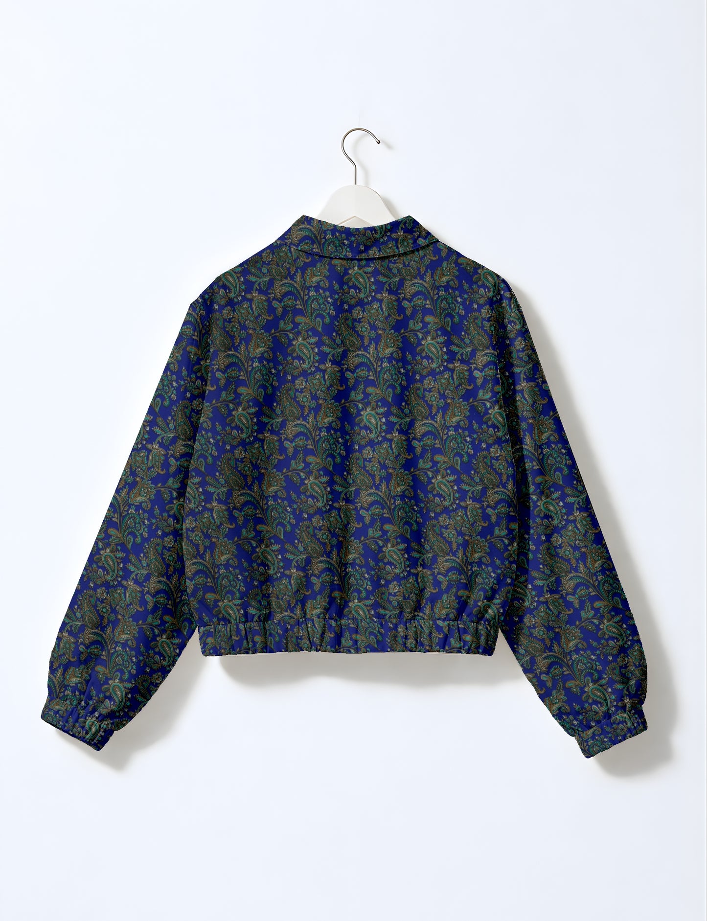Women's cropped bomber jacket with twin metallic front zippers, welt pockets, elasticated hem and cuffs, and contrast sari print lining.