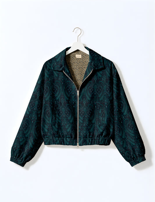 Women's cropped bomber jacket with twin metallic front zippers, welt pockets, elasticated hem and cuffs, and contrast sari print lining.