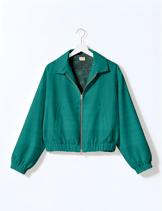 Women's cropped bomber jacket with twin metallic front zippers, welt pockets, elasticated hem and cuffs, and contrast sari print lining.